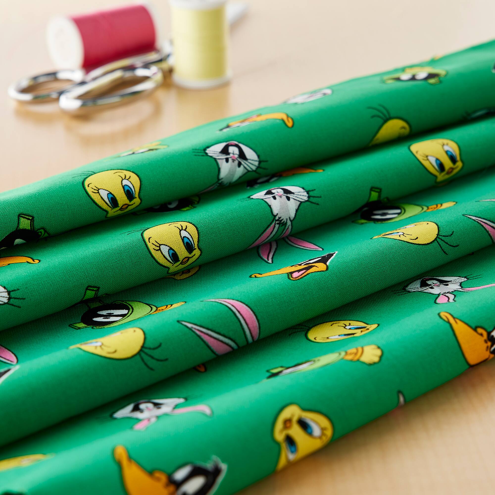 Camelot® Fabrics Looney Tunes™ Green Faces Toss Cotton Fabric